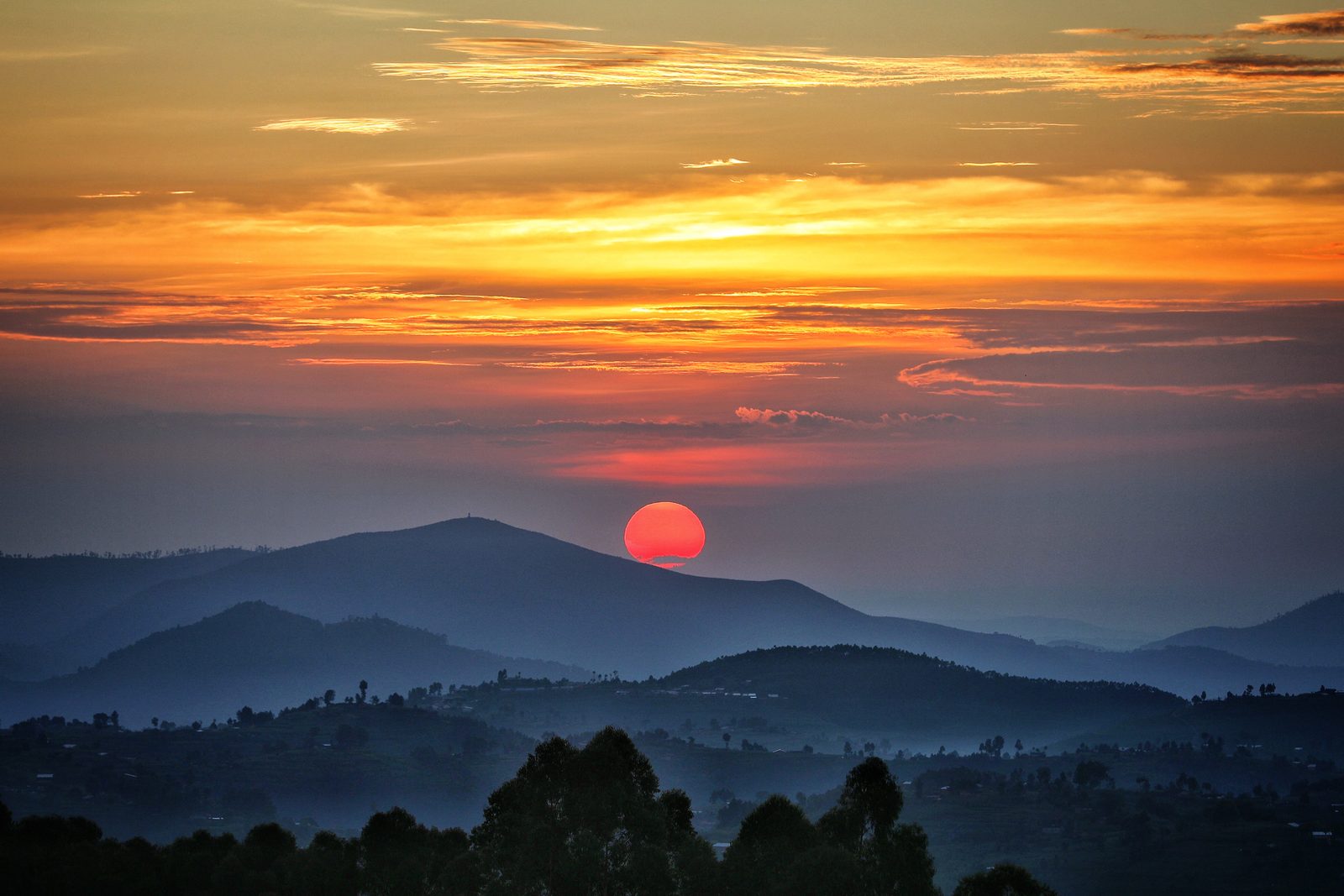 Coucher de soleil sur les collines du Rwanda, illustrant le relief étudié lors de nos missions environnementales